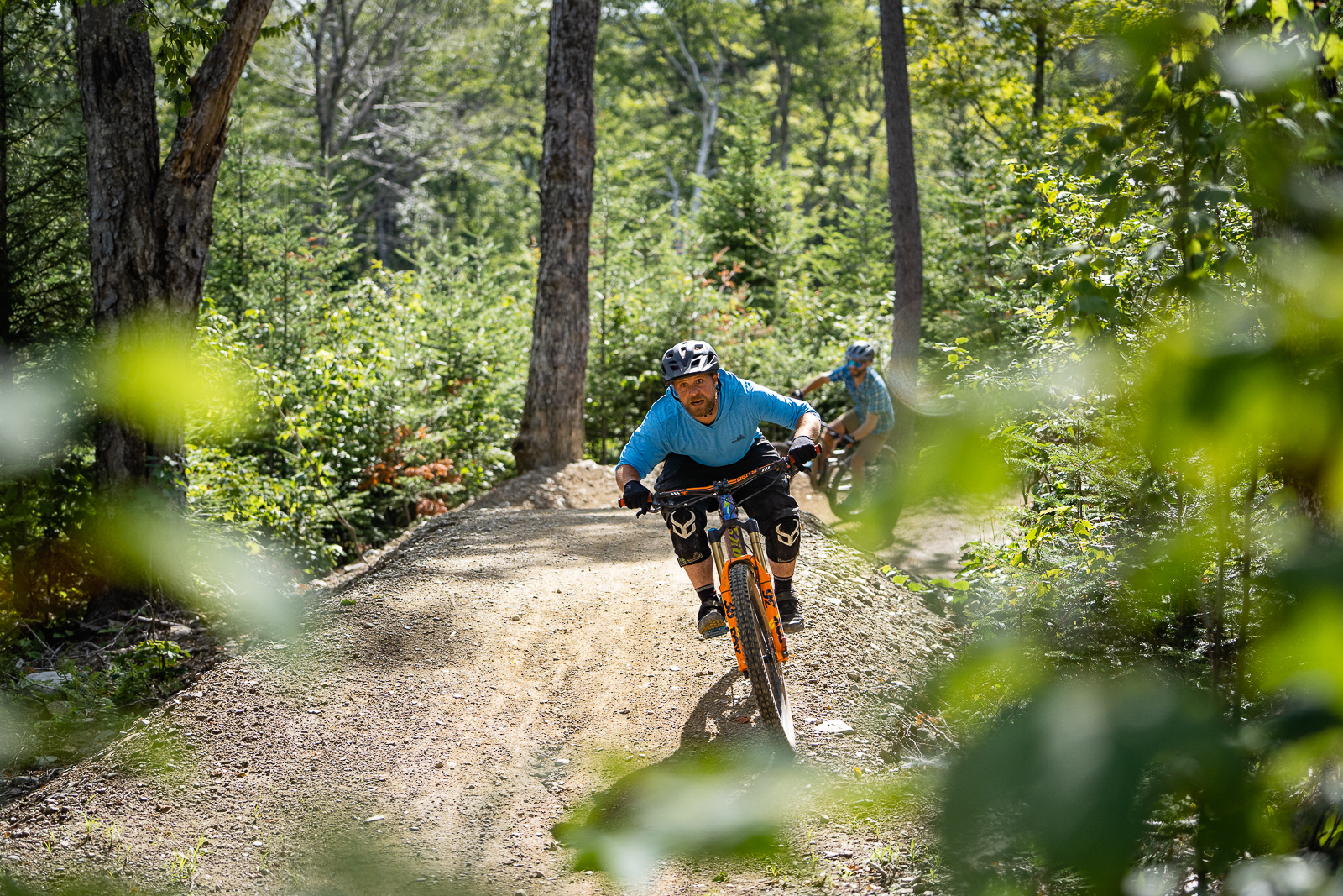 mountain bike rider cruising blue shirt