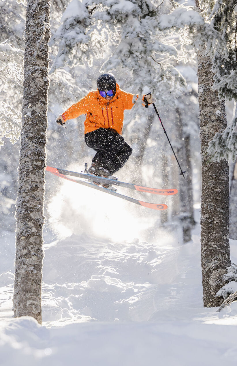 Skier orange jacket jumping Casablanca trees