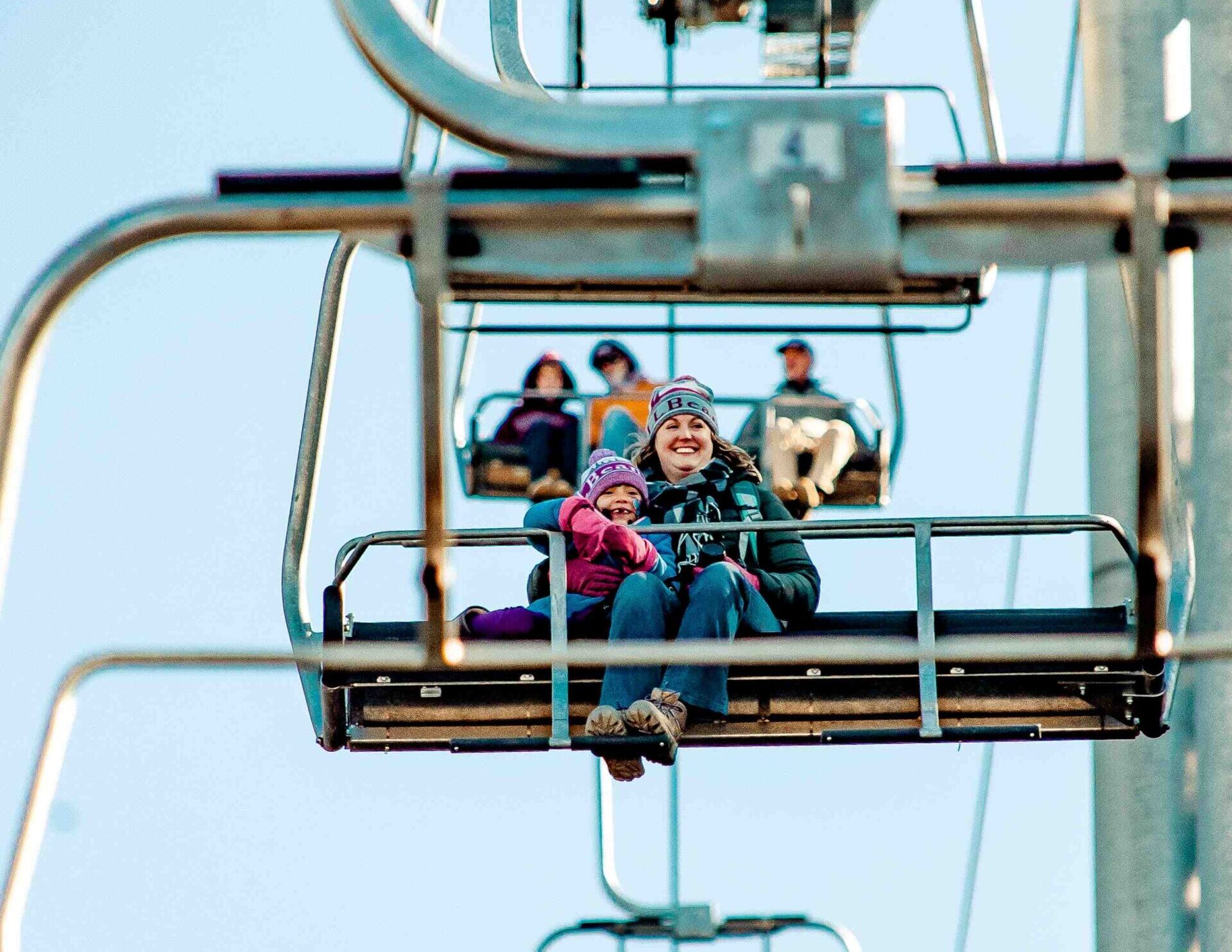 Two people seated on the Rangeley Quad
